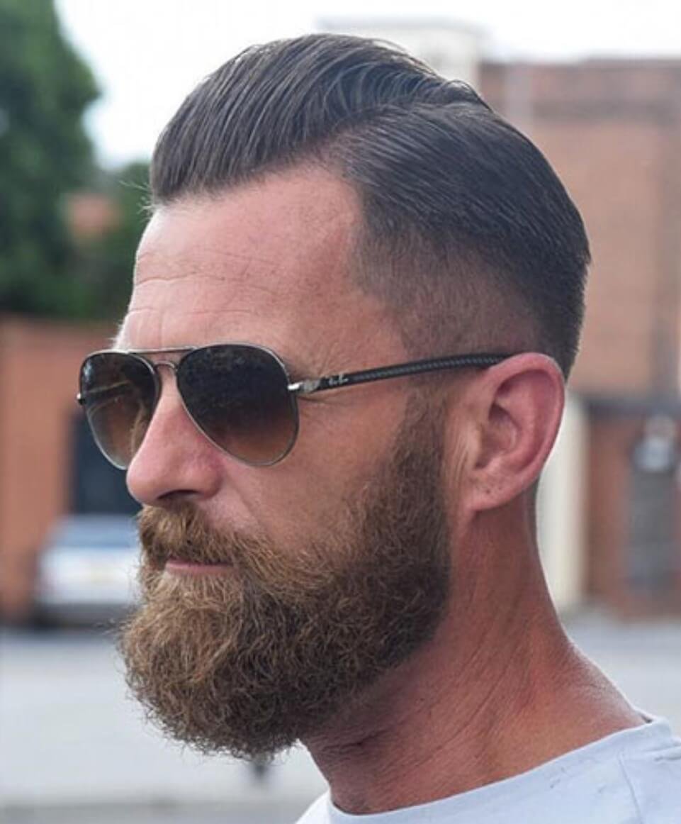 Slicked back pomp with center fade men's hairstyles for thin hair

